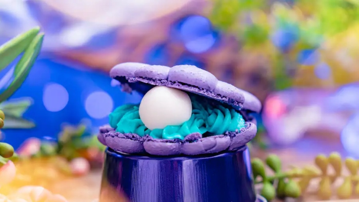 Purple Pineapple Shell Macaron is a purple macaron filled with blue pineapple buttercream and a chocolate pearl that is located at Disneyland
