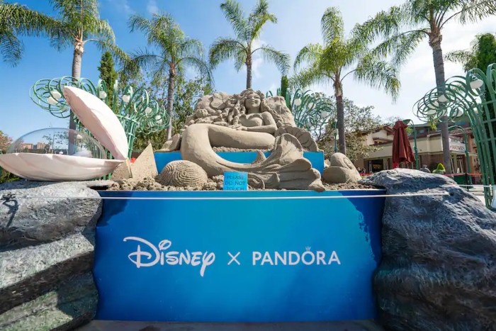 A Disney and Pandora sand castle display of The Little Mermaid that is located in the Downtown Disney District.
