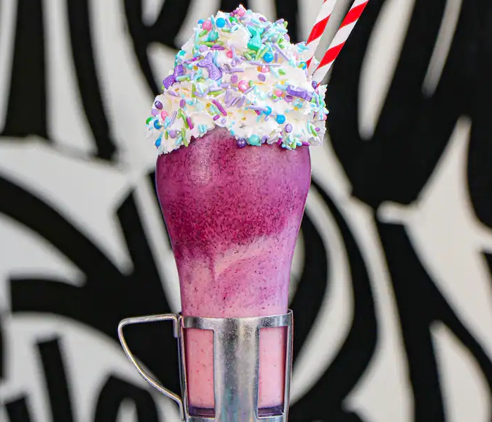 A colorful shake from Black Tap Craft Burgers & Shakes in the Downtown Disney District. This shake is inspired by The Little Mermaid.