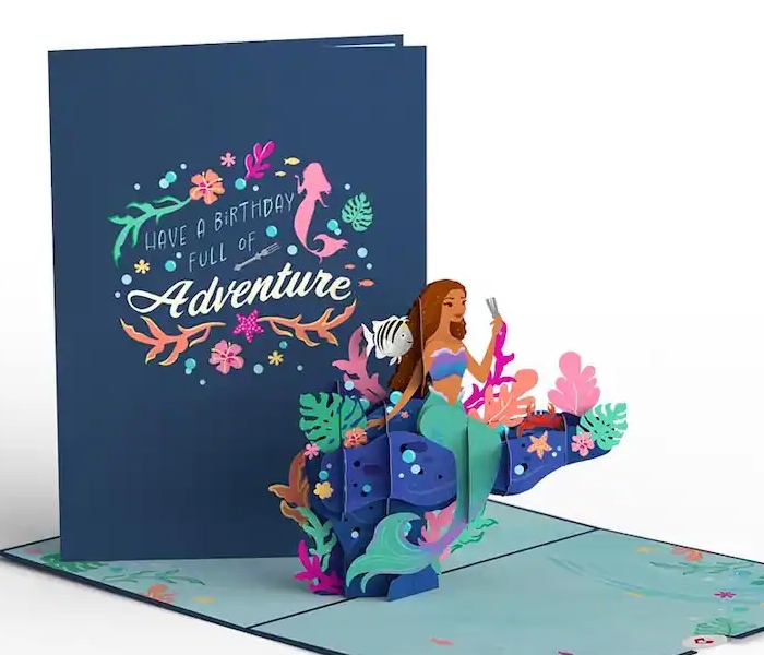 You can buy a The Little Mermaid inspired birthday card is from Lovepop that is located in the Downtown Disney District.