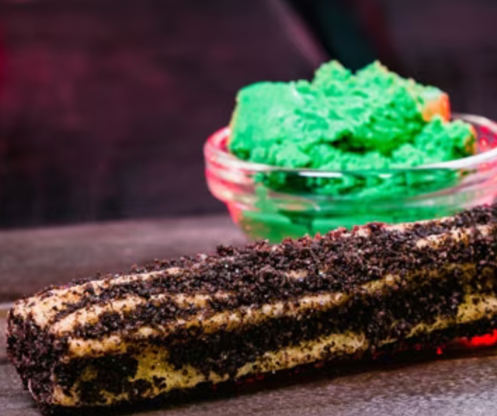 This Halloween at Disneyland, you can get a Maleficent Churro with a Peanut Butter Dipping Sauce!