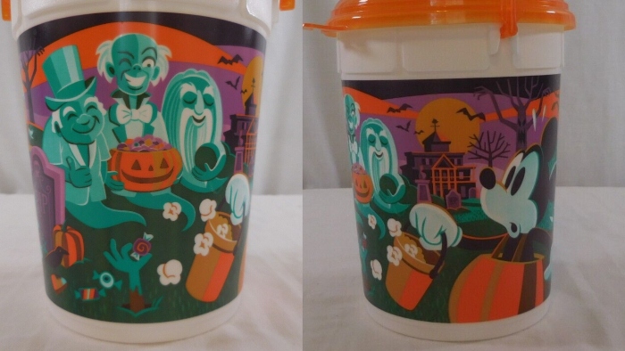This souvenir popcorn bucket shows Mickey and friends trick or treating at the Haunted Mansion and they run into the hitchhiking ghosts.